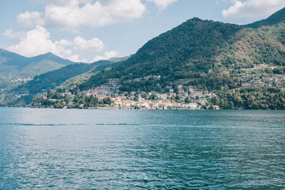 Scenic view of sea and mountains against sky