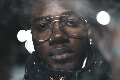 Close-up portrait of young man at night