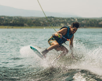 Full length of man wakeboarding in sea