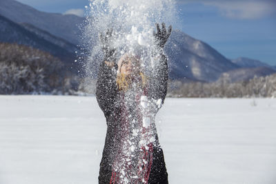 Woman is having winter fun on a snowy, sunny day in lika, croatia