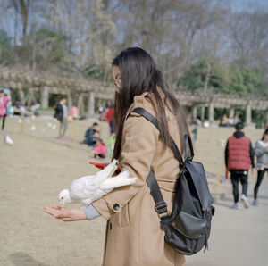 Rear view of woman standing outdoors