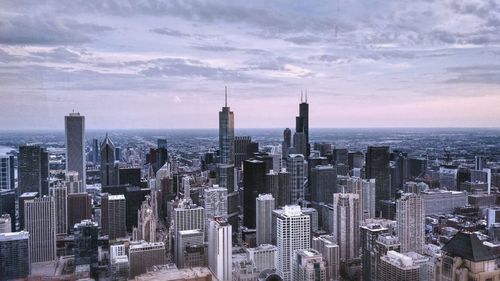 Buildings against cloudy sky