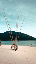 Fishing net on beach against sky