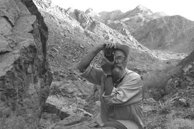 Rear view of man standing on mountain