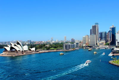 Panoramic view of modern buildings against clear blue sky