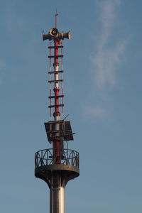 Low angle view of communications tower against sky