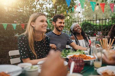 Young couple looking at food outdoors