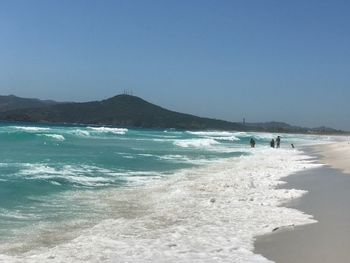 Scenic view of beach against clear sky