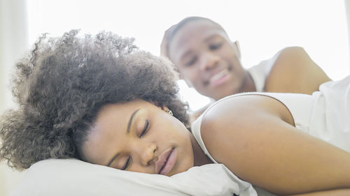 Portrait of young couple lying in bed