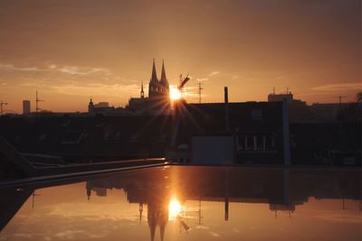 View of city lit up at sunset