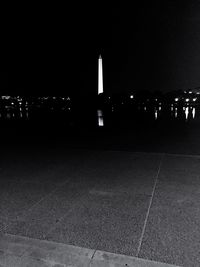 Illuminated city against sky at night