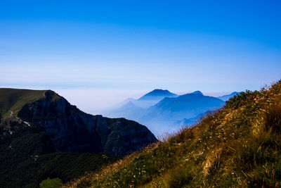 Scenic view of mountains against clear blue sky