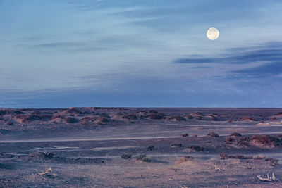 Scenic view of desert against sky at dusk