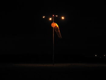 Low angle view of illuminated street light against sky at night