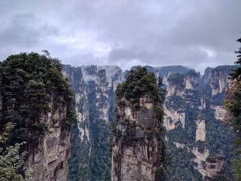 Panoramic view of rocks and trees against sky