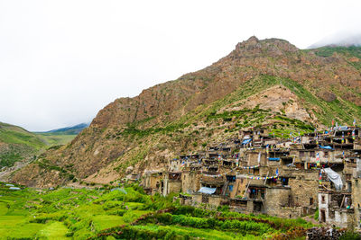 Scenic view of houses and mountains against clear sky