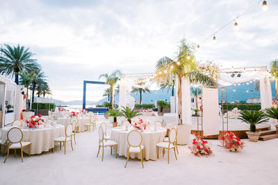 Empty chairs and tables at beach