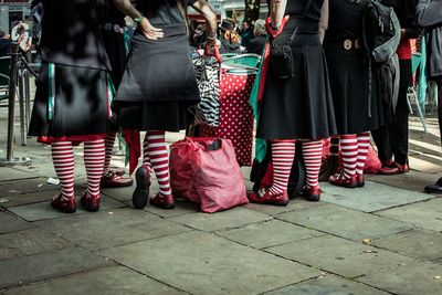 Low section of people standing on street