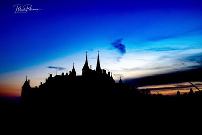 Silhouette of temple building against sky at sunset