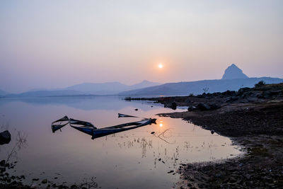 Scenic view of lake against sky during sunset