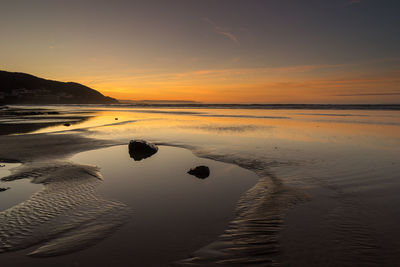 Scenic view of sea against sky during sunset