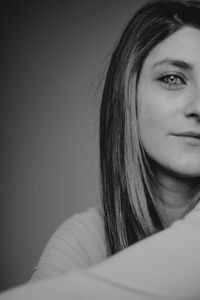 Close-up portrait of a young woman looking away at home