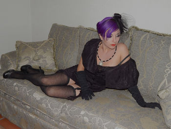 Rear view of young woman sitting outdoors