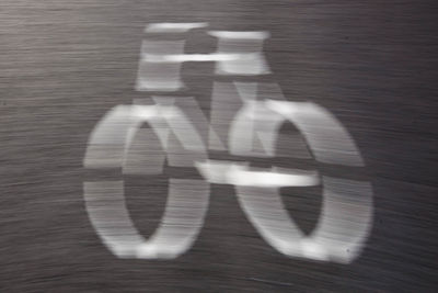 Shadow of man on bicycle in city