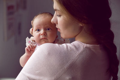 Close-up of cute baby girl at home