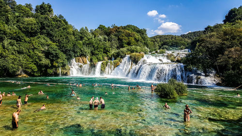 Panoramic view of waterfall in forest against sky