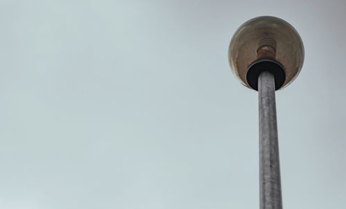 Low angle view of street light against sky