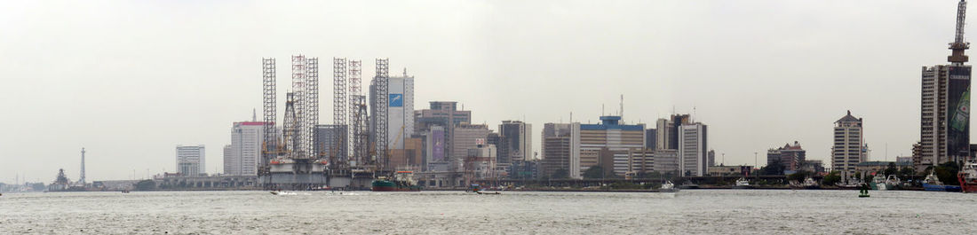 Buildings in city against clear sky