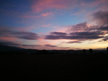 Silhouette landscape against sky during sunset