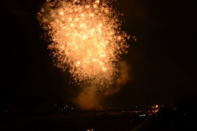 Low angle view of firework display at night