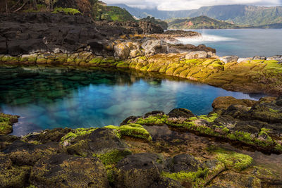 Long exposure of the calm waters of queen's bath, a rock pool off princeville on north kauai