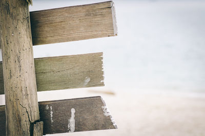 Close-up of wooden building by sea against sky