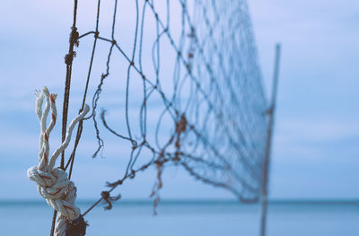 Close-up of beach volleyball net gainst sky