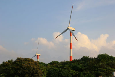 Low angle view of windmill on landscape against sky