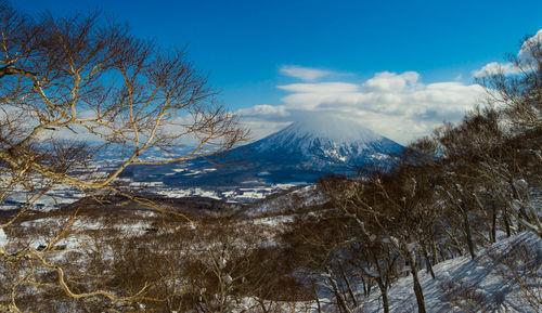 Scenic view of mountains against blue sky