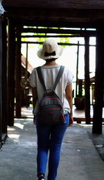 Rear view of man standing in corridor