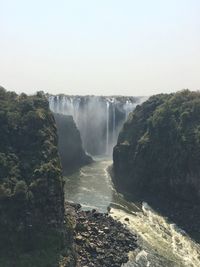 Scenic view of waterfall against clear sky