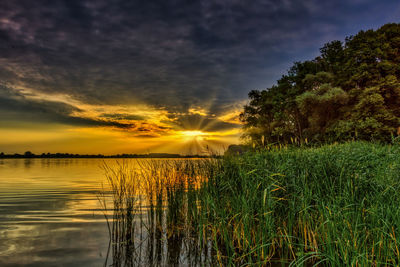 Scenic view of lake against sky during sunset