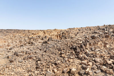 Rock formations on landscape against clear sky