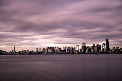 View of modern buildings in city against cloudy sky