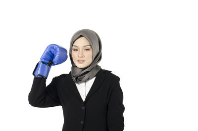 Portrait of a young woman against white background