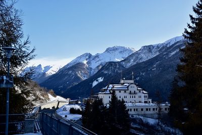 Snow covered mountains against clear blue sky