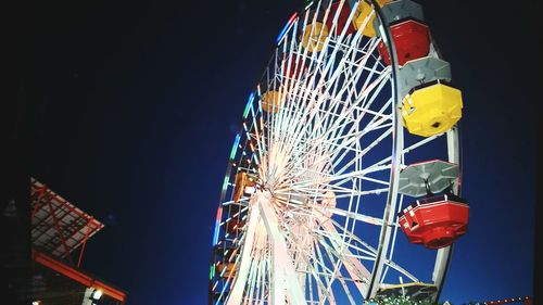 Low angle view of ferris wheel against sky at night