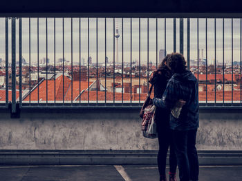 Couple kissing against cityscape