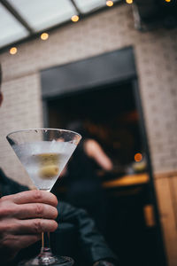 Midsection of woman holding wine glass