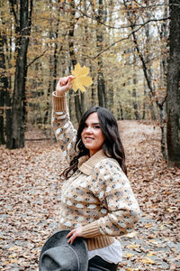 Portrait of a beautiful young woman, autumn, forest, outdoors.